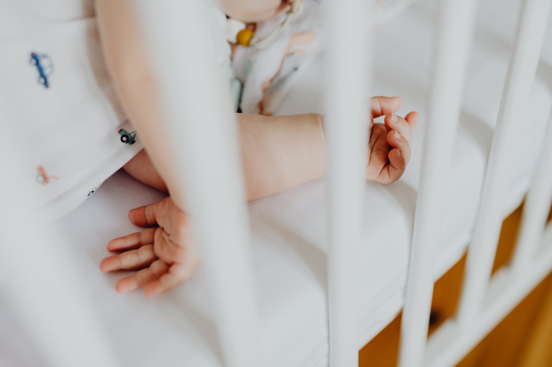 phot of a baby s arms in a crib
