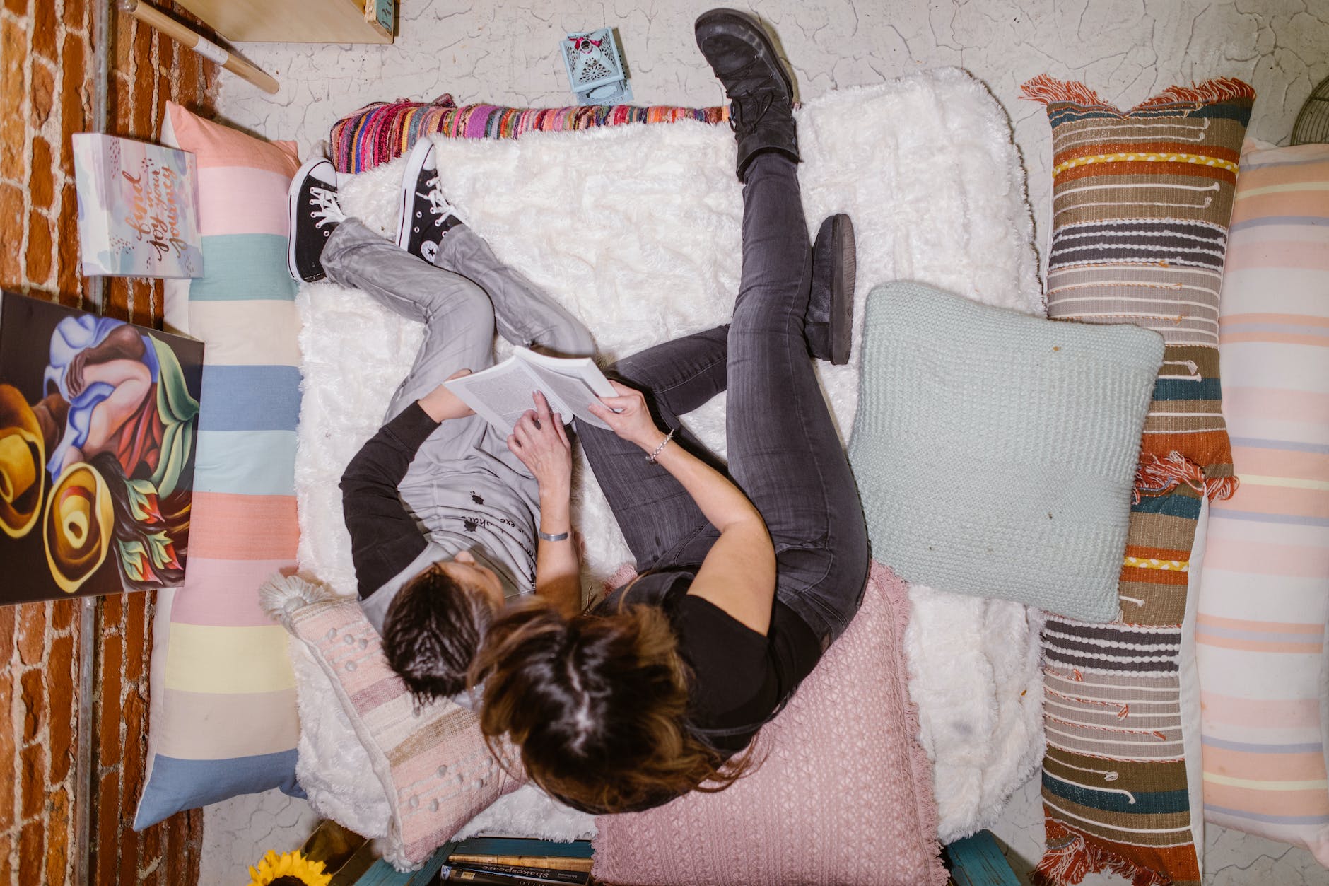overhead shot of a woman and her son reading a book