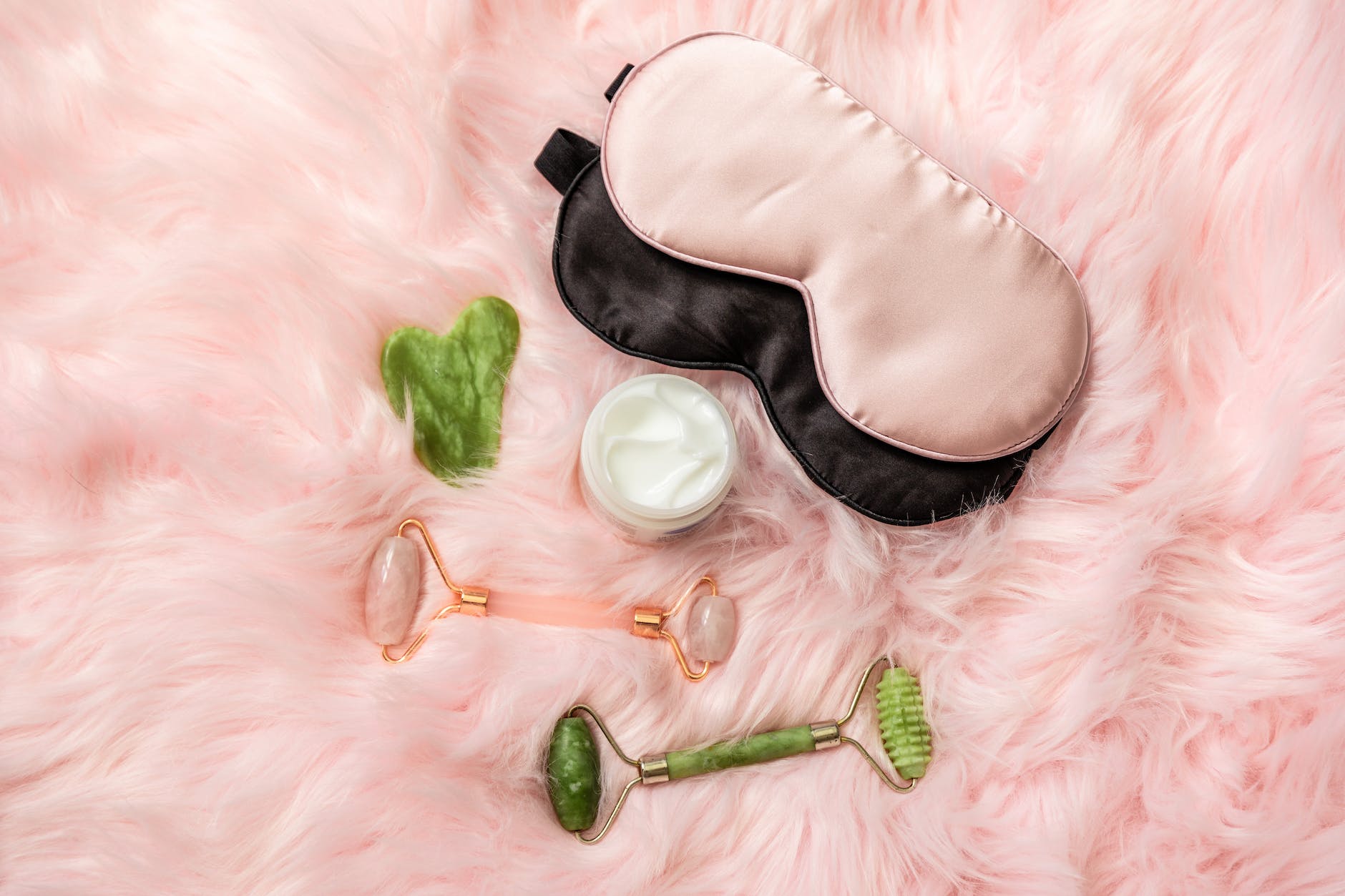 beauty care products over a pink furry fabric